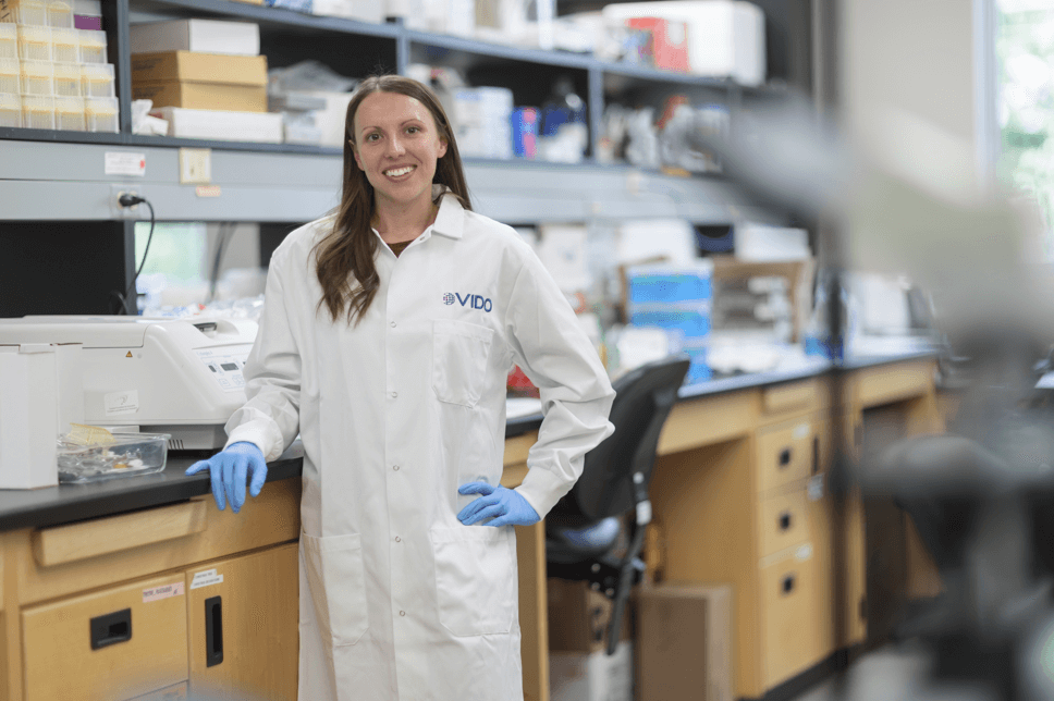 Scientist stands in front of lab bench