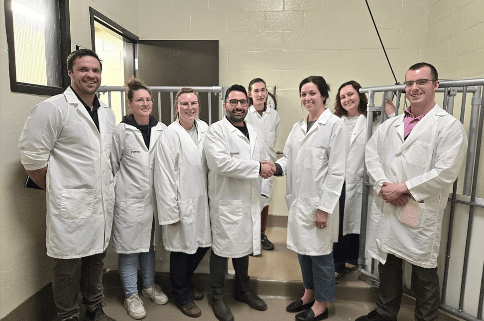 Group of people in lab coats standing in surgical suite